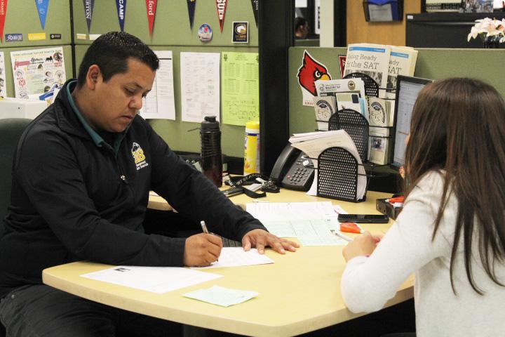 Ignacio Aguilera, Educational Advising Specialist, helps out an ETS student go over her A-G requirements in order to be on track to graduate.
