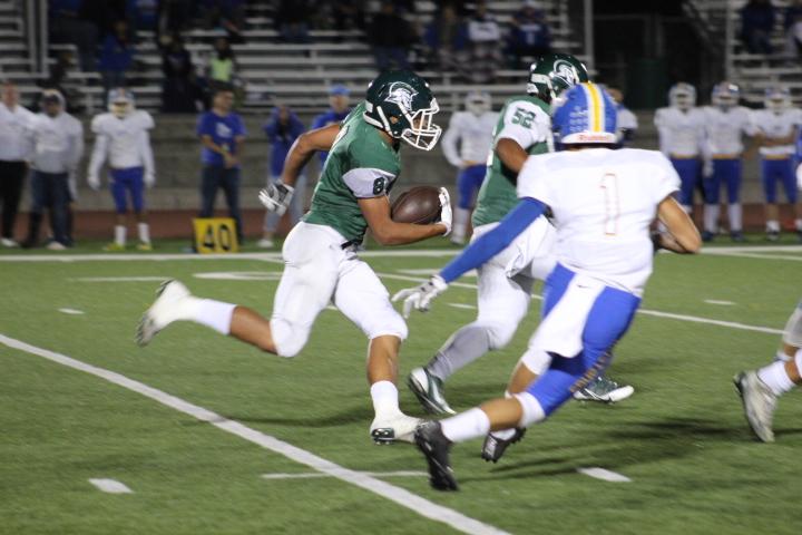 Running+back+Javion+Macias+looks+to+gain+a+first+down+against+Gilroy.+Despite+dropping+the+league+opener+to+the+Mustangs%2C+Coach+Chaidez+felt+the+team+was+improving.