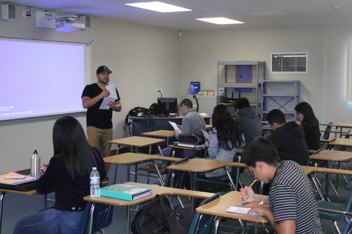 Mr. Edeza, an AP Exam coordinator, gathers a group of students as they register for their upcoming AP exams.