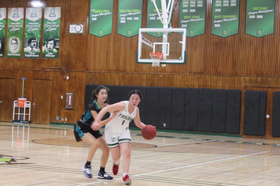 Briana Mejia drives to the basket against Christopher in the Trojans 54-47 victory on 1/28/2020. The victory put the team firmly in first place at 5-0.