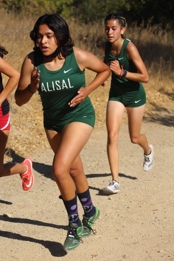 At Center Meet #1 at Christmas Hill Park in Gilroy, Anahi Rosas and Abigail Bustamante push through the hill together. The team finished in 3rd place, with Abigail Bustamante placing 8th with a time of 22:17 and Anahi Rosas placing 9th with a time of 22:24. “I felt a lot of pain building up in my legs, but I knew I had to keep up with Anahi if we wanted a top 3 finish as a team,” said Bustamante. 

