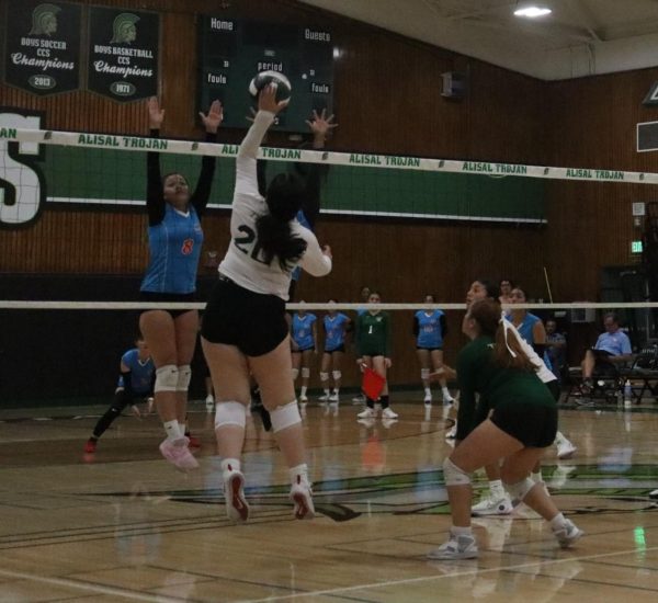 In a preseason ,matchup, outside hitter Nicole Arreguin blocks a hit from North High, scoring a point for the Trojans. The Vikings won 4-1.
