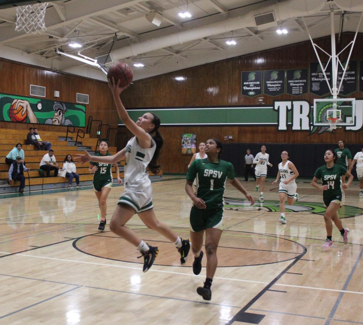 Against St. Patrick-St. Vincent, senior Lesly Rodriguez soars in for a layup. Unfortunately, the Trojans came up short, losing 43-51. 