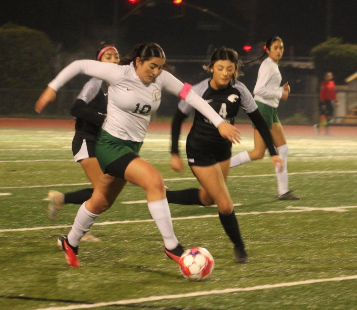 In an intense match against Watsonville, senior captain Aileen Cardenas beats her opponent and carries the ball to the offense. The Trojans lost the fight with a final score of 2-0. “Soccer means a lot to me and I always try to play with the best of my effort. I understand there are times I do make mistakes but I try to see those mistakes as a way to learn,” Cardenas said. “Throughout the sport, there’s a lot of challenges you’re going to face, so just don’t let it get to you mentally.” 
