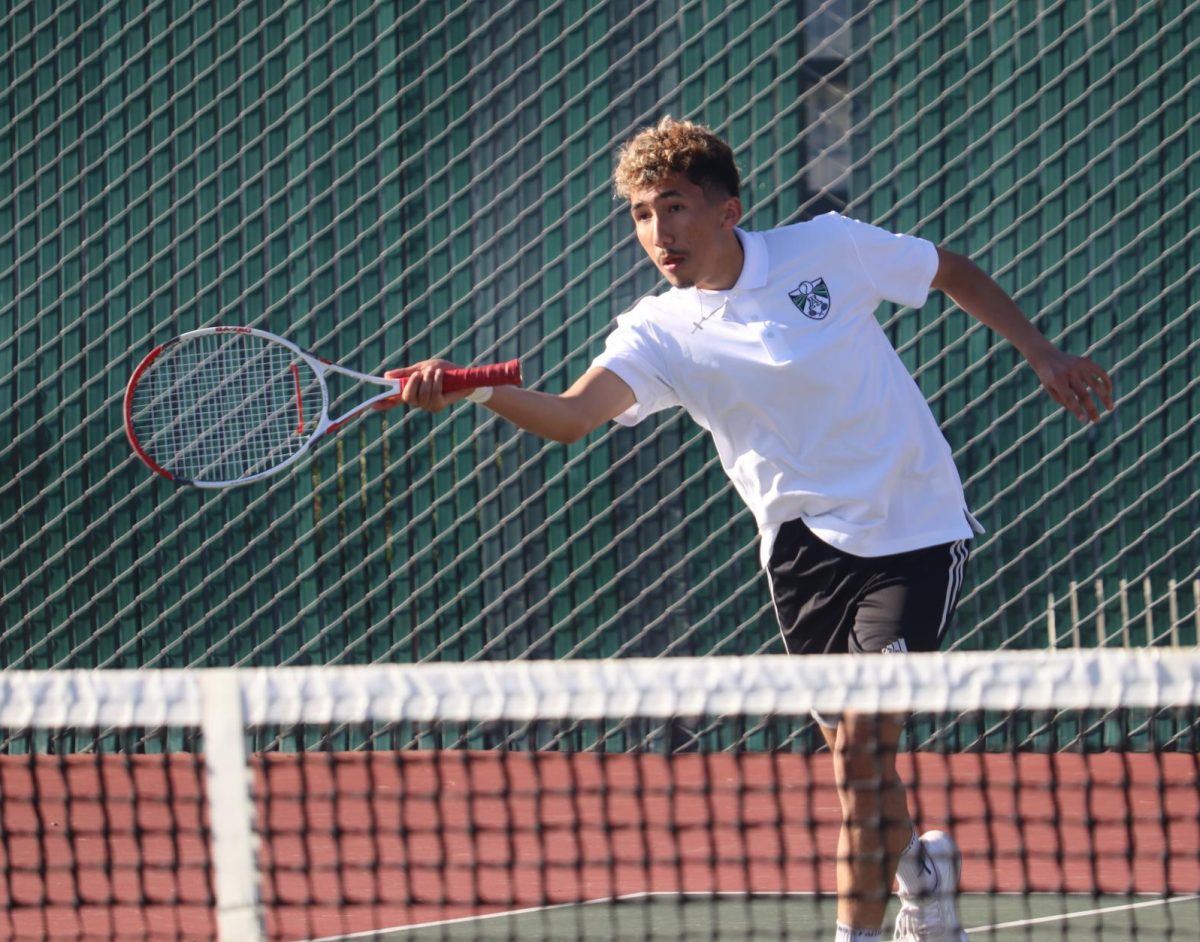Senior+Francisco+Estrada+hits+a+forehand+in+his+doubles+match+against+Gonzales+on+March+19th%2C+2024.%0A