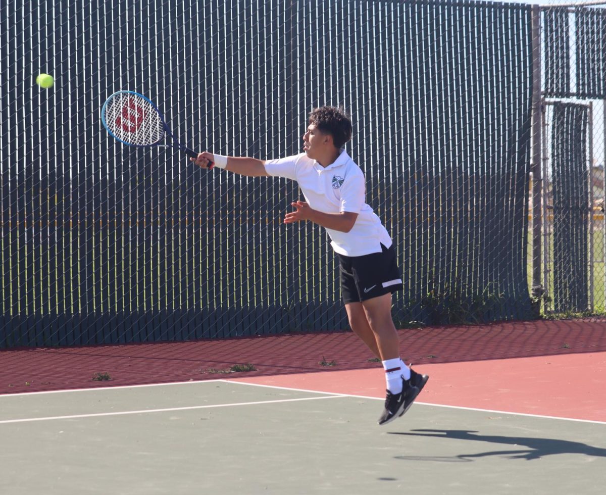 Senior Isaiah Jacinto leaping to   hit the ball in his doubles match win against Rancho San Juan (2-0) on Senior Night. “I was just focused on winning the first set,” Jacinto said.
