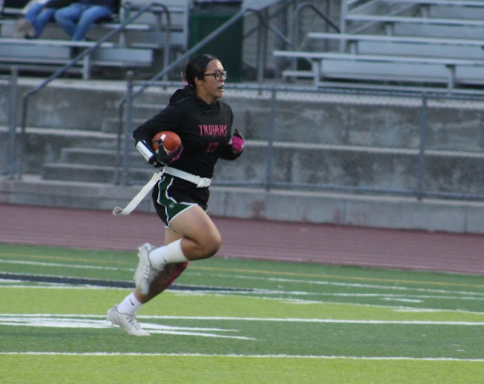 Senior safety Aileen Gonzalez returns an interception for touchdown in the first quarter against Alvarez on October 9. The Trojans defeated the Eagles 65-6 to even their record at 5-5.