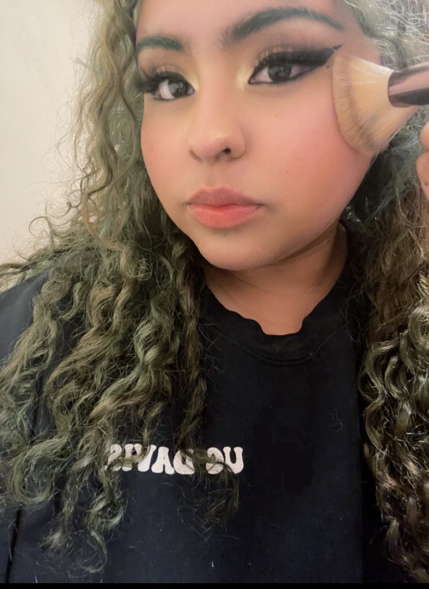   In this picture, I am blending out my blush in an upward direction. When I wear certain hairstyles, I like to apply makeup at an upwards angle to sculpt my face.
