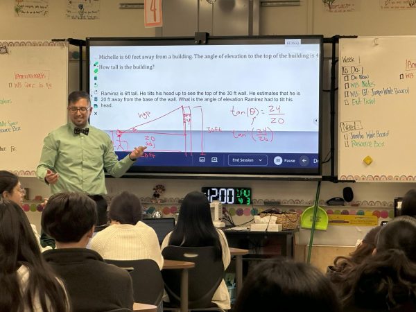 Math 2 teacher, Pedro Ramirez, teaches a lesson on trigonometry using real-world examples.  “It gives a lot of access to a lot of students to get more education as far as it goes, like to get college credit before they even go into a college,” Ramirez said. “Also helps decrease the equity gap we have with other more economically advantaged areas.