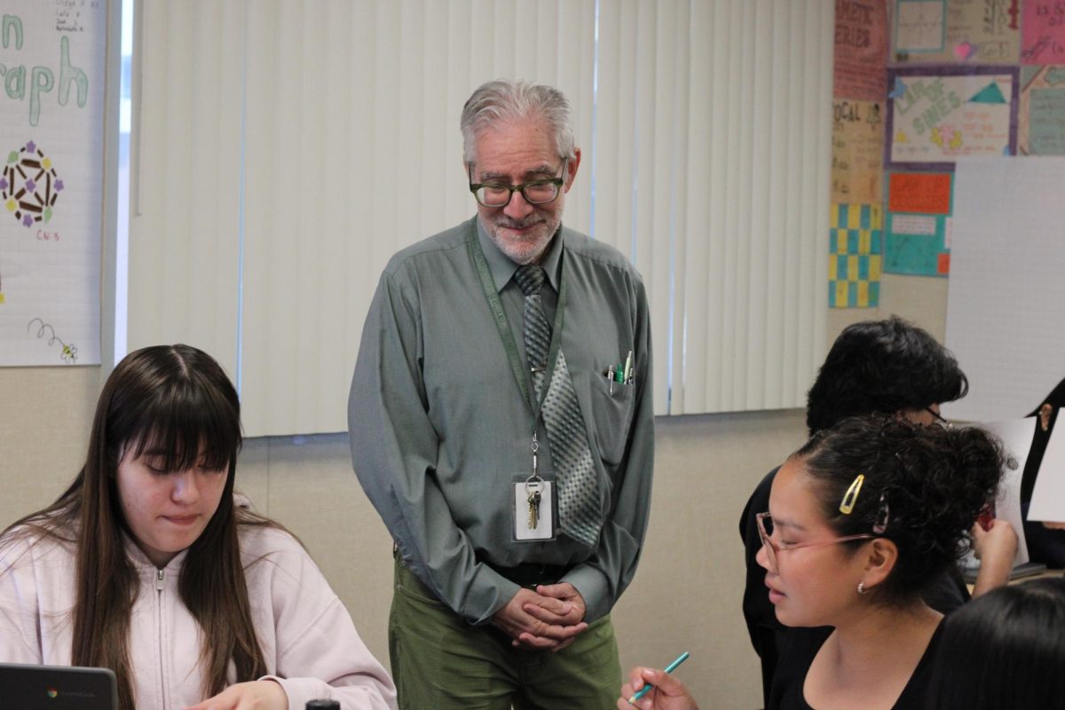 Making math both educational and fun, math teacher Gary Golub has his fifth period  College Level Mathematics class work in groups on a graph coloring project. “I feel fortunate that I’ve been able to create an enjoyable math experience for students,” he said. 
