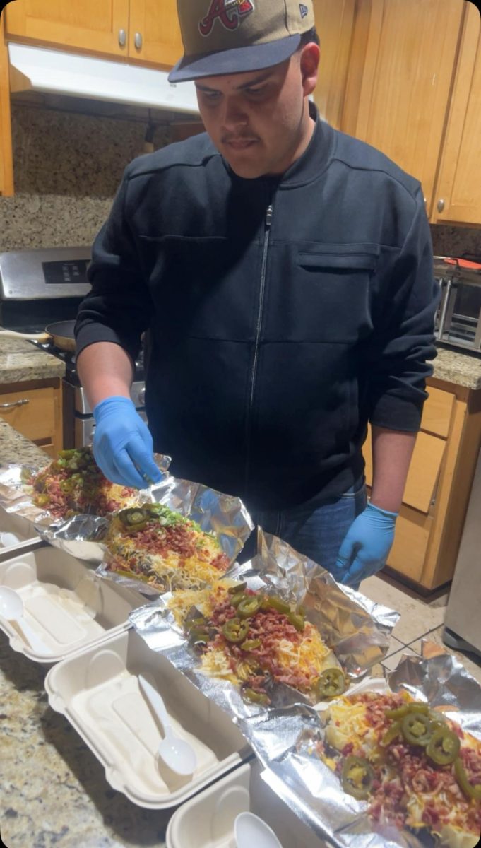 Senior Hugo Acero prepares potatoes for his evening deliveries. “I don’t charge for deliveries because I feel that sales are higher when I keep the price down,” he said. “It’s still profitable though."
